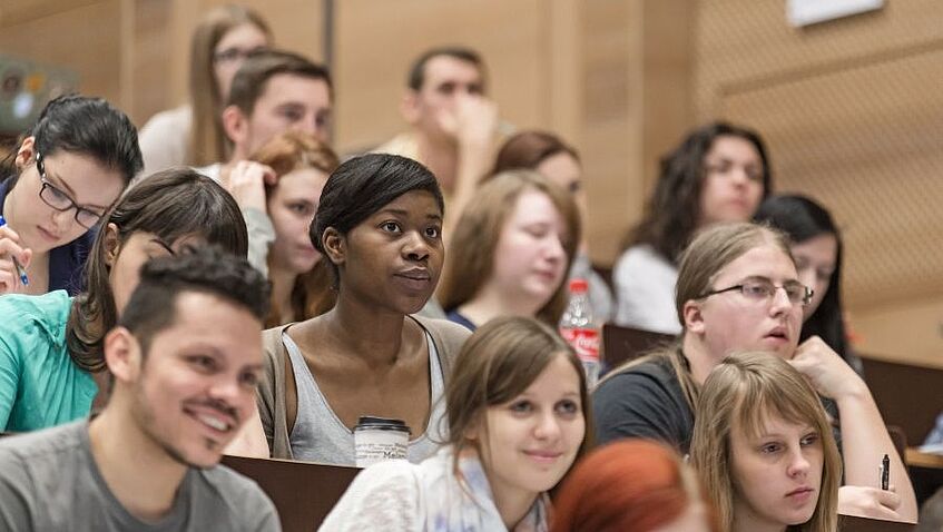 Students sitting in a lecture hall.