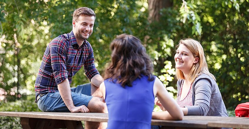 Students are sitting in the student space outdoor.