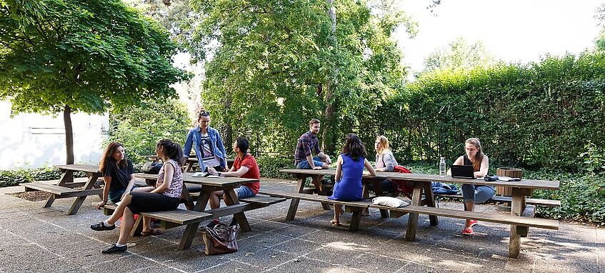 Students are sitting in the student space outdoor.